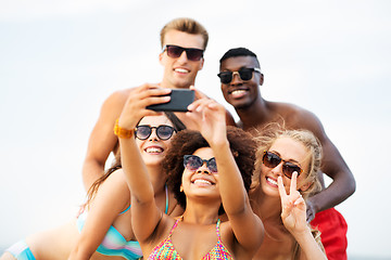 Image showing happy friends taking selfie on summer beach