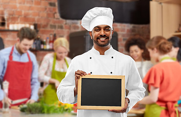 Image showing happy indian chef with chalkboard at cooking class