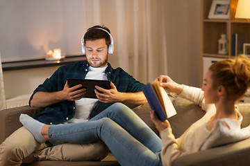 Image showing couple with tablet computer and book at home