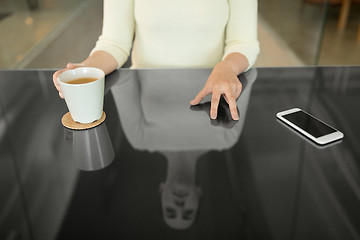 Image showing woman with coffee using black interactive panel