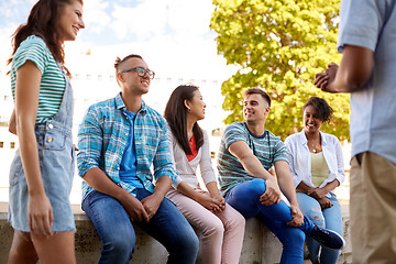 Image showing happy international friends talking in city