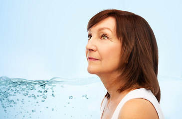 Image showing portrait of senior woman over blue water