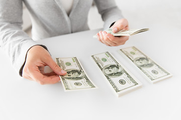 Image showing close up of woman hands counting us dollar money