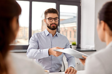 Image showing male employee having job interview with recruiters