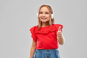 Image showing smiling girl in headphones listening to music