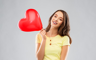 Image showing teenage girl with red heart-shaped balloon