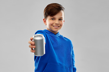 Image showing smiling boy in blue hoodie holding can drink