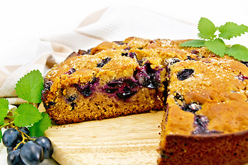 Image showing Pie with black grapes on board