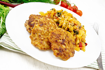 Image showing Fritters meat with cabbage in plate on light board