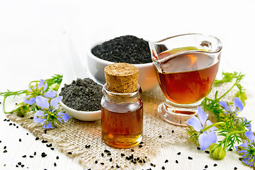 Image showing Oil kalingi in bottle and gravy boat on wooden board