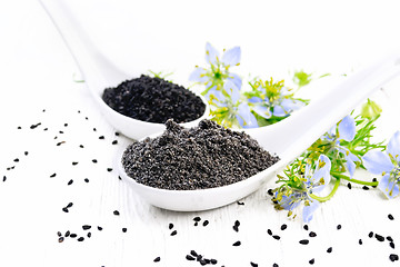 Image showing Flour and seeds of kalingi in spoons on light board