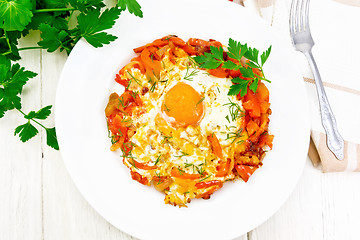 Image showing Scrambled eggs with vegetables in plate on board top