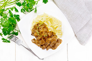 Image showing Goulash of beef with mashed potatoes in plate on board top