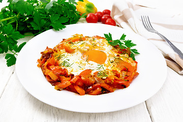 Image showing Scrambled eggs with vegetables in plate on white board