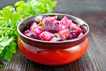 Image showing Salad of beets and potatoes in bowl on dark table