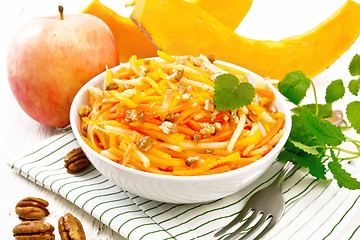 Image showing Salad of pumpkin and apple in bowl on light board