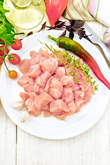 Image showing Chicken breast raw sliced in plate with vegetables on board top