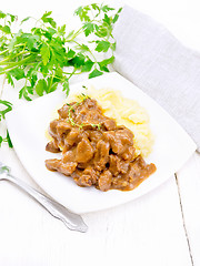 Image showing Goulash of beef with mashed potatoes in plate on table