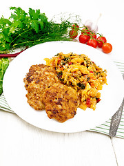 Image showing Fritters meat with cabbage in plate on towel