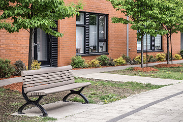 Image showing Bench in front of a modern brick building
