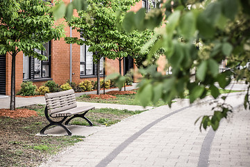 Image showing Modern building seen through green leaves