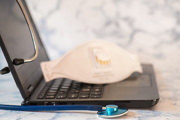 Image showing Stethoscope and notebook Tablet in the fingers of hand