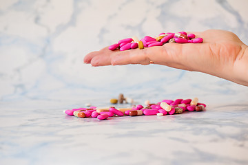 Image showing Tablets in the palm of hand Tablet in the fingers of hand