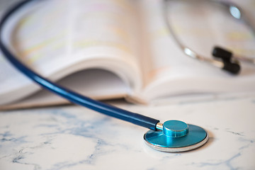 Image showing Stethoscope and book Tablet in the fingers of hand