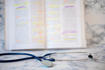 Image showing Stethoscope and book Tablet in the fingers of hand