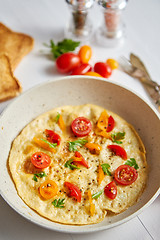 Image showing Tasty homemade classic omelet with cherry tomatoes