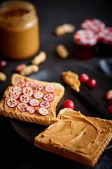 Image showing Toasts bread with homemade peanut butter served with fresh slices of cranberries