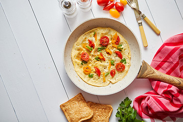 Image showing Tasty homemade classic omelet with cherry tomatoes