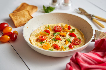 Image showing Tasty homemade classic omelet with cherry tomatoes