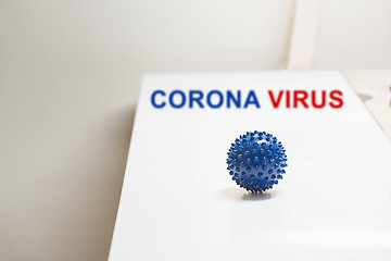 Image showing Shot of microscope virus close up. Coronavirus concept Tablet in the fingers of hand