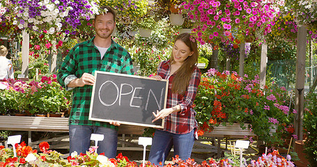 Image showing Two florists with open sign in their shop