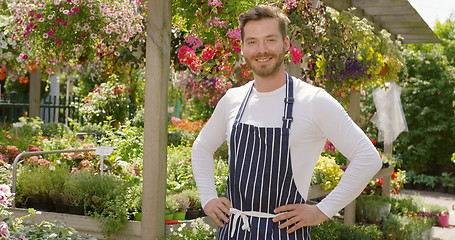 Image showing Smiling handsome gardener man standing and posing