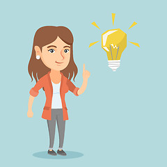 Image showing Young caucasian student pointing at idea lightbulb