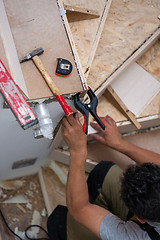 Image showing carpenter installing wooden stairs