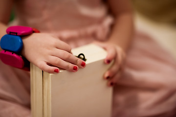 Image showing little girl enjoying while playing with mother\'s jewelry