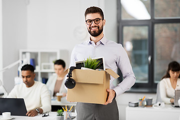 Image showing happy male office worker with personal stuff