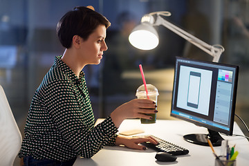 Image showing designer with smoothie at computer at night office