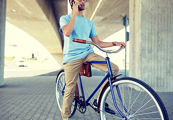 Image showing man with smartphone and fixed gear bike on street