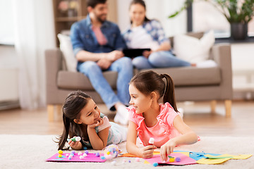 Image showing happy sisters doing arts and crafts at home