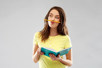 Image showing teenage student girl with notebook and pencil