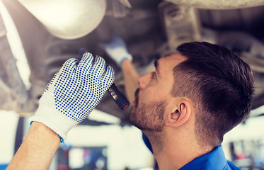 Image showing mechanic man or smith repairing car at workshop