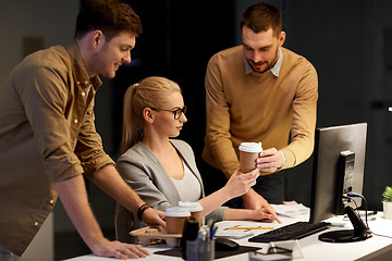 Image showing business team with computer working late at office