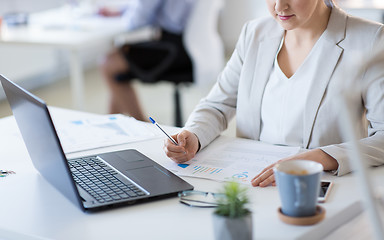 Image showing businesswoman with papers working at office