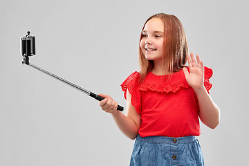 Image showing girl taking picture by smartphone on selfie stick