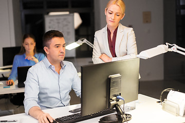 Image showing business team with computer working late at office