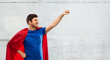 Image showing man in red superhero cape over concrete background